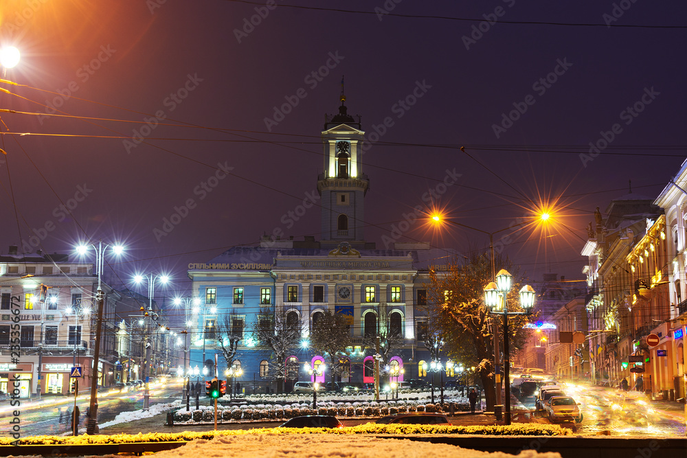 City Hall. The central square in the night. Blur background of street road. Night lights on the Golovna streets of Chernivtsi.