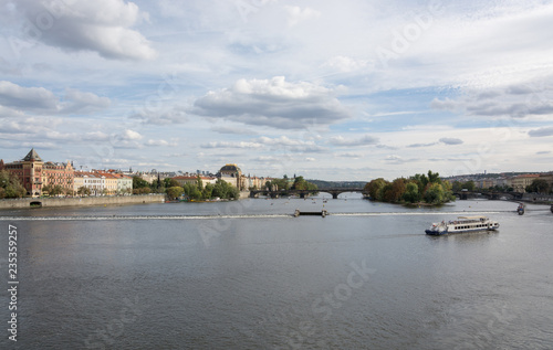 Prague waterfront panorama on a cloudy day, with Vltava river, Legion bridge and the National Theater landmarks in sight 