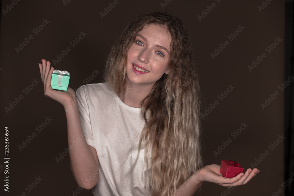 The portrait of a young girl with two gift surprise present boxes The portrait of a young girl with two gift surprise present boxes