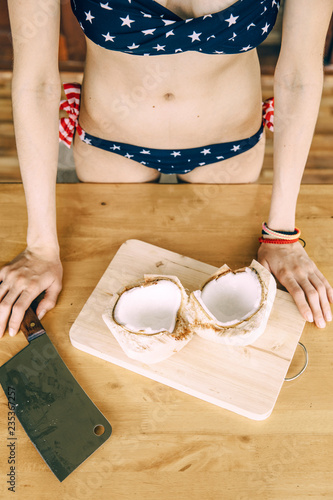 Woman Cutting A Coconut