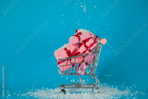 Christmas sales. Buying gifts for the new year, the concept. The shopping cart is full of gift boxes