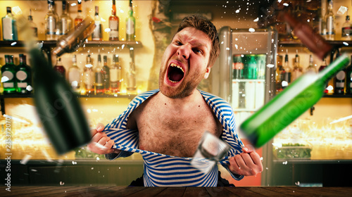 Drunk bartender tears his vest at the bar counter photo