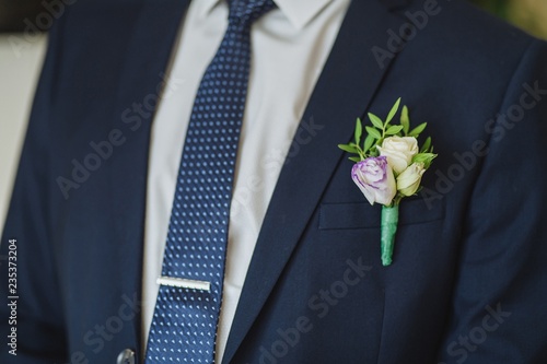 Boutonniere groom with flowers on the wedding day.