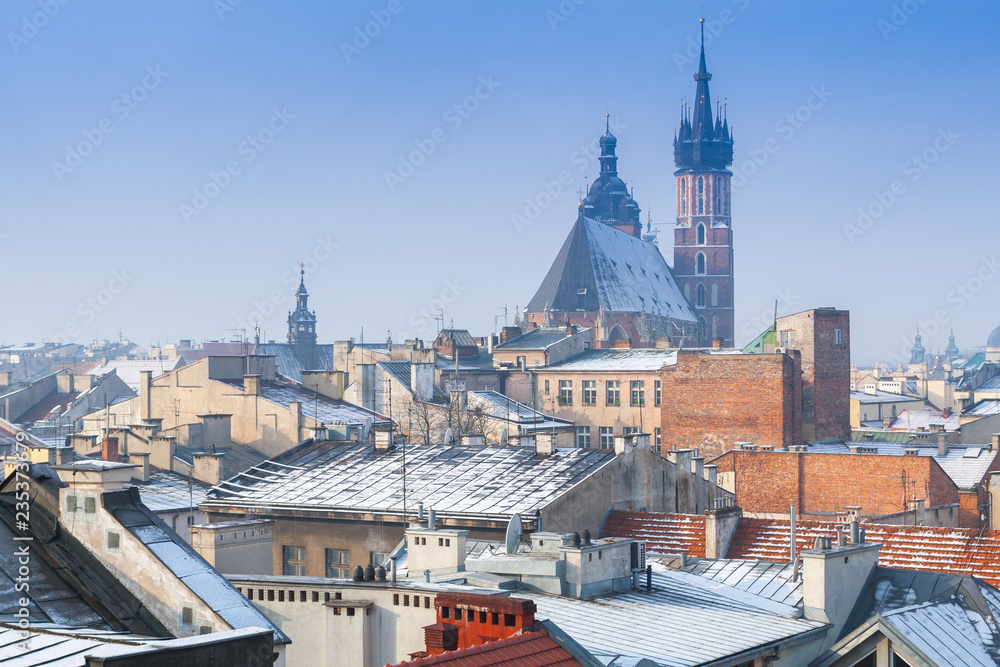 Krakow in Christmas time, aerial view on snowy roofs in central part of city. St. Mary's Basilica on Main Square. Poland. Europe.
