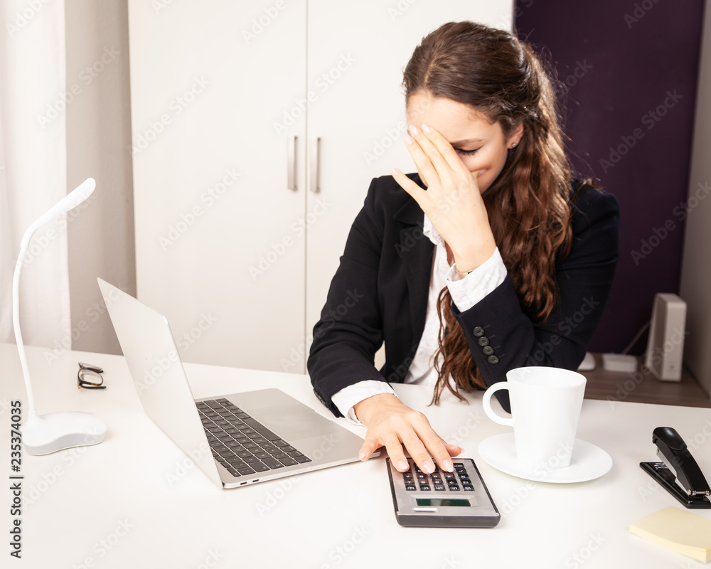 Young Business Woman working sitting at desk stressed out angry on laptop Young Business Woman working sitting at desk stressed out angry on laptop