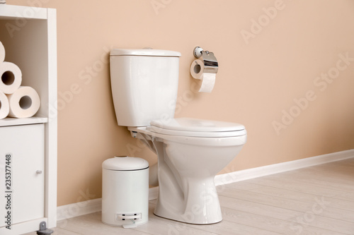 Fototapeta Naklejka Na Ścianę i Meble -  Holder with toilet paper roll on wall in bathroom