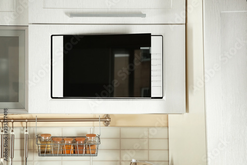 Vászonkép Open modern microwave oven built in kitchen furniture