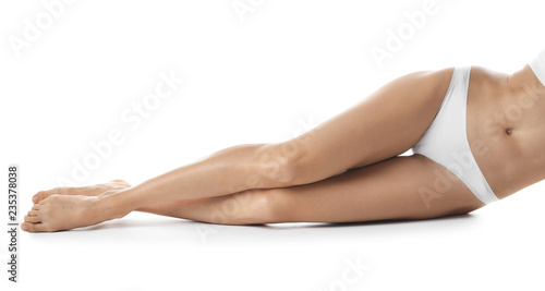 Young woman with beautiful long legs on white background  closeup