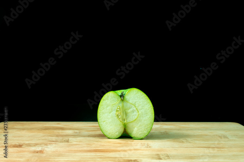 Fresh organic green apple on wood