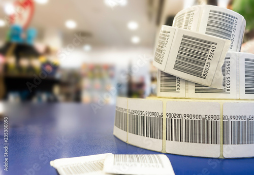 Three RFID sticky tags rolls with a store out of focus in the background