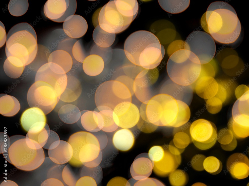 bright orange and yellow round blurred lights abstract on a black night background