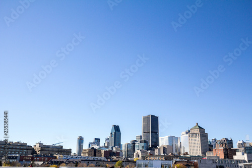 Montreal skyline  with the iconic buildings of the old Montreal  Vieux Montreal  and the CBD business skyscrapers taken from the port. Montreal is the main city of Quebec    the second city in Canada