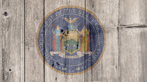 USA Politics News Concept: US State New York Seal Wooden Fence Background