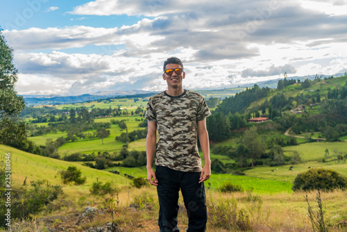 Man with glasses on top of a mountain. Travel, vacation. © Jair Fonseca