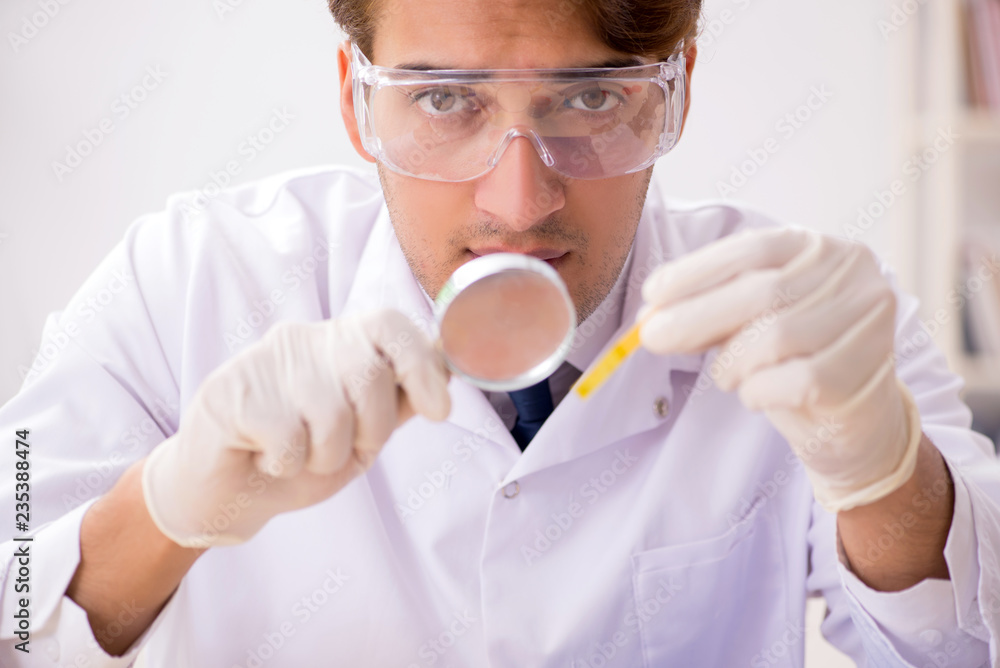 Chemist in the lab checking with ph strips Chemist in the lab checking with ph strips