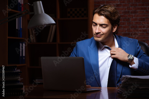 Young businessman working in the office at night 
