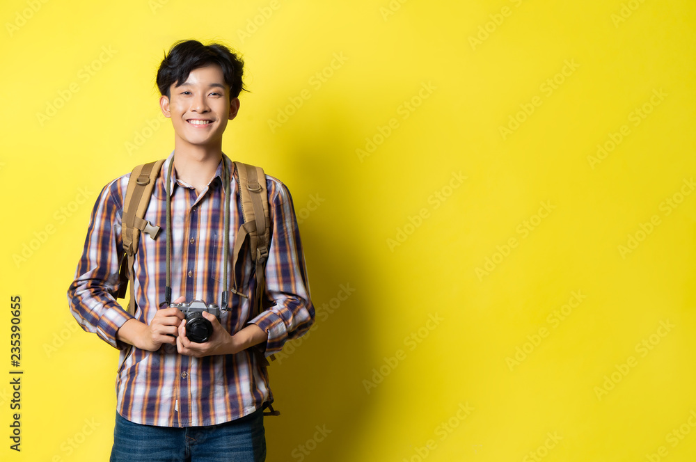 Asian guy looks handsome a tourist, he was smiling. Asian guy looks handsome a tourist, he was smiling.