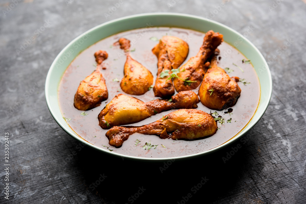 Chicken leg / drumstick curry or Murg Tangri/tangdi masala. Served in a bowl over moody background. Selective focus Chicken leg / drumstick curry or Murg Tangri/tangdi masala. Served in a bowl over moody background. Selective focus