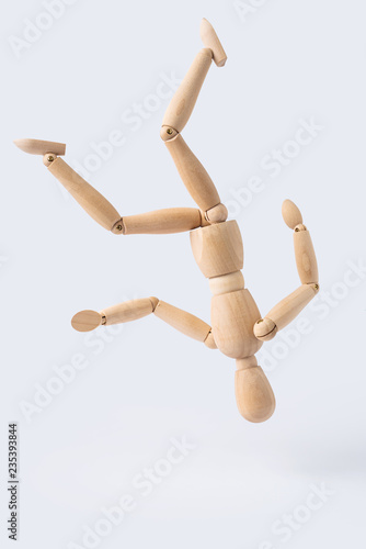 falling wooden mannequin isolated on white background