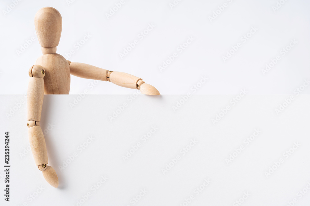 wooden mannequin hold empty board