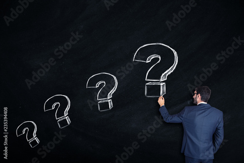hand chalk with question sign in board