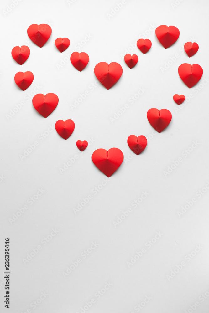 Handmade craft 3D paper hearts on a white background forming a heart shape for a Valentine's Day