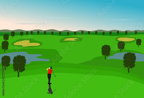 Golfers are golfing in the field with mountains as background.