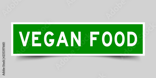 Square green sticker label in word vegan food on gray background