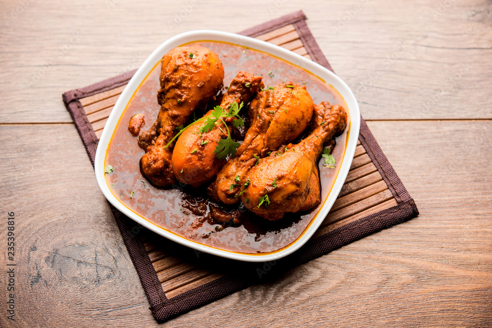 Chicken leg / drumstick curry or Murg Tangri/tangdi masala. Served in a bowl over moody background. Selective focus Chicken leg / drumstick curry or Murg Tangri/tangdi masala. Served in a bowl over moody background. Selective focus
