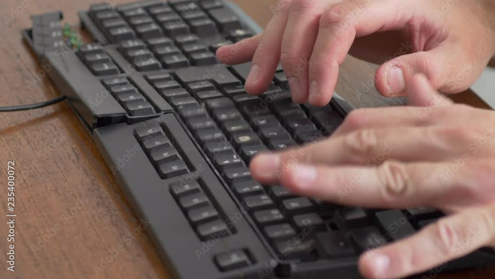 Close up shot of males hands Typing on an old beat up black keyboard Close up shot of males hands Typing on an old beat up black keyboard