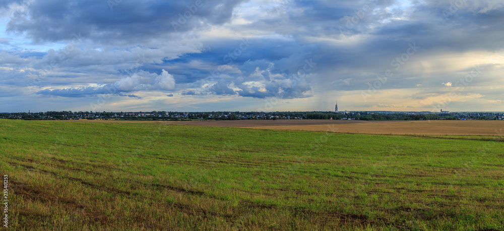 The provincial Russian city on the horizon with the silhouette of the bell tower