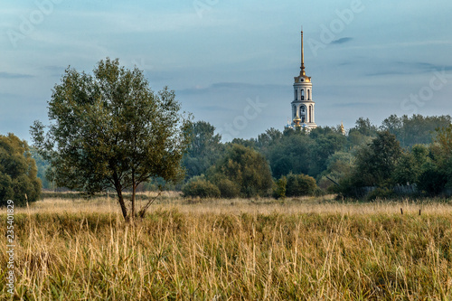 View of the bell tower in the Russian city of Shuya from the side of the field