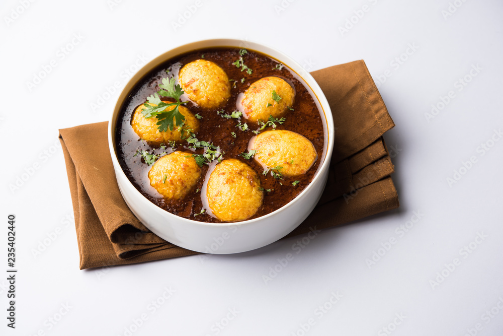 Fried egg curry or anda masala served in a bowl. selective focus Fried egg curry or anda masala served in a bowl. selective focus