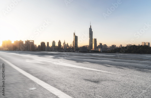 Panoramic skyline and modern buildings with empty road