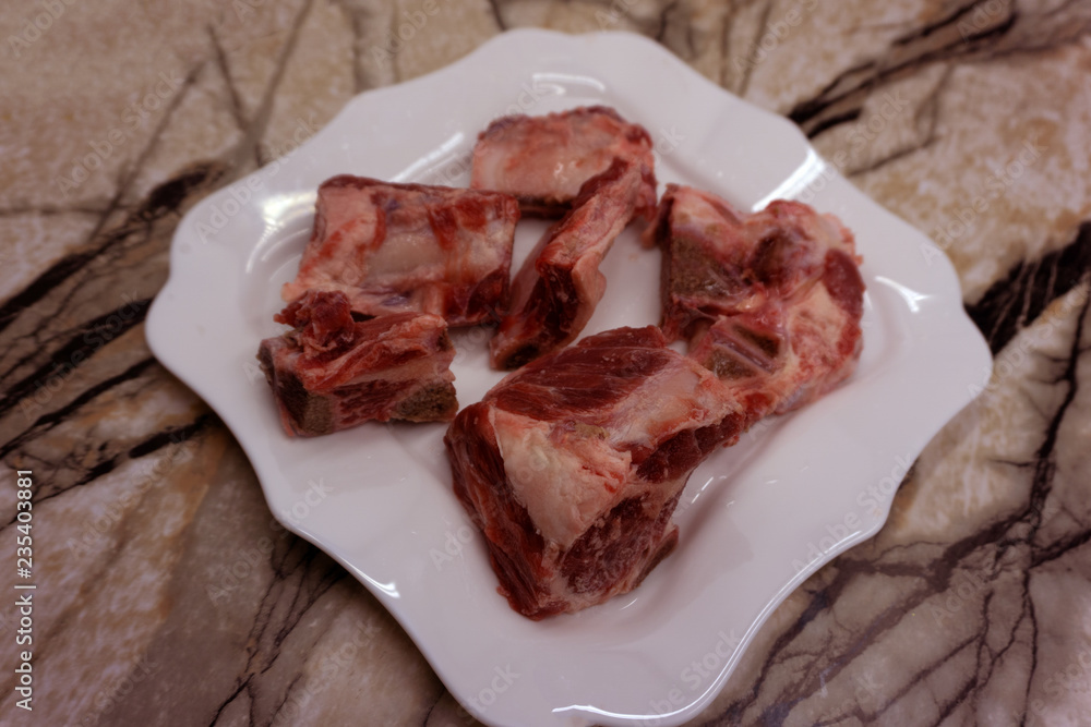 Raw beef meal in bowl, fresh, natural food for dog or cat, isolated on white background. Top view. Raw beef meal in bowl, fresh, natural food for dog or cat, isolated on white background. Top view.
