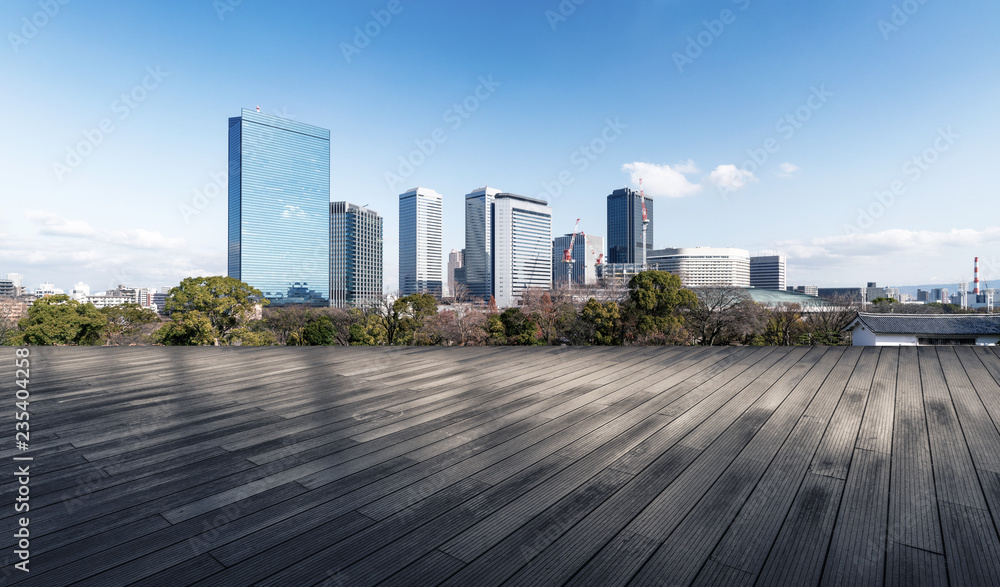 Panoramic skyline and modern buildings with empty boardwalk in Osaka