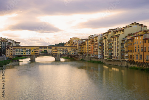 View of the Golden Bridge and the city embankment on a September cloudy morning. Florence  Italy