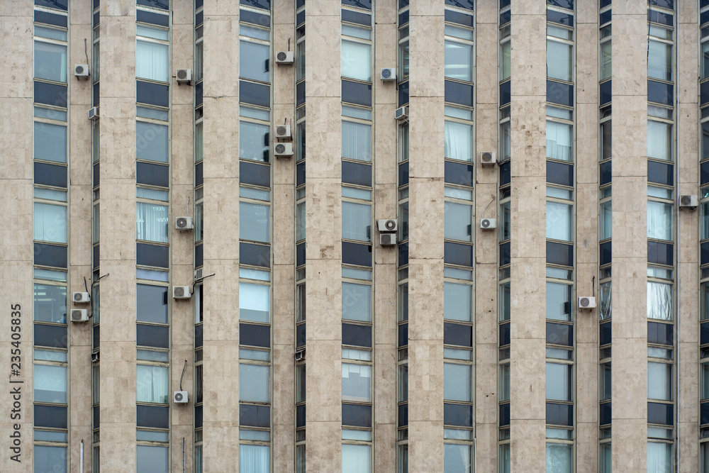 Pattern of high-rise office building with numerous air conditioners on the facade Pattern of high-rise office building with numerous air conditioners on the facade