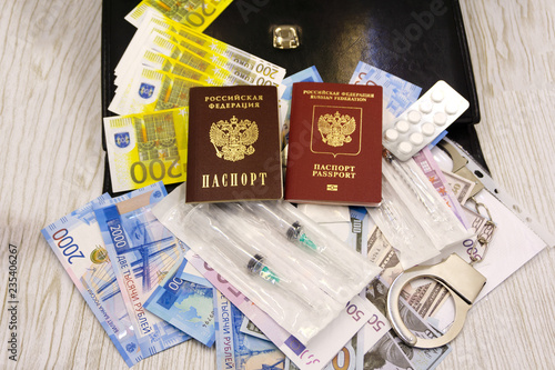A South African passport and medication on a wooden table top. Travel medication concept image.