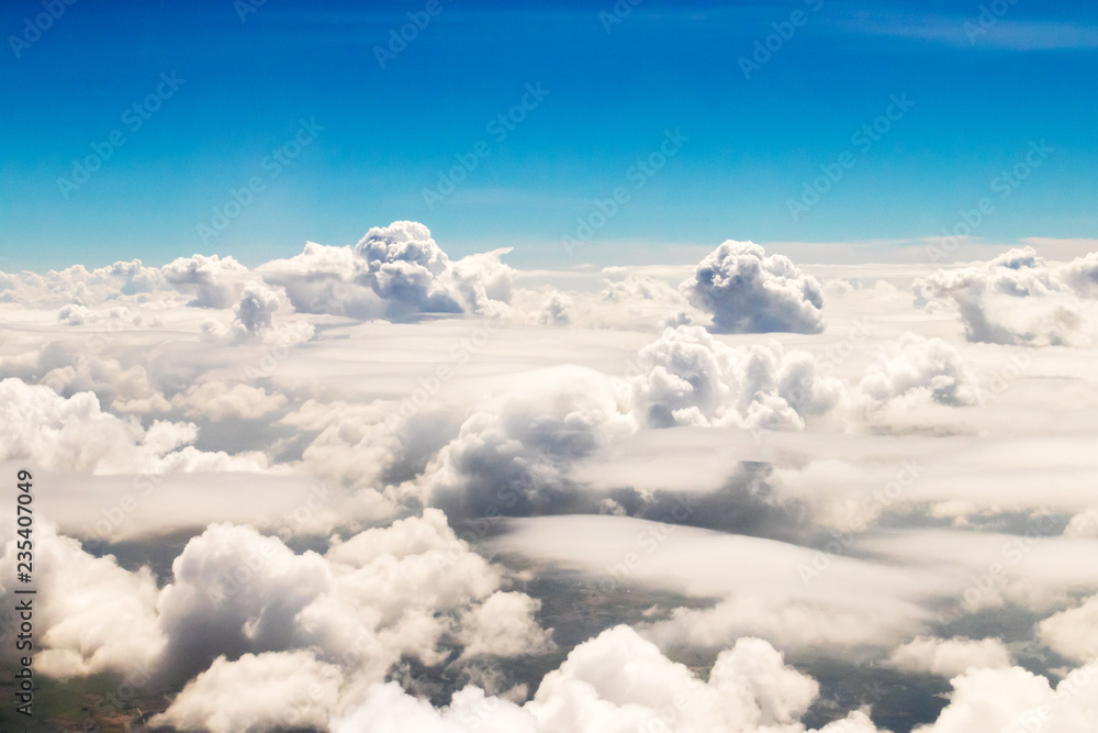 Nice view seen from the airplane. White fluffy and blue sky with clouds. Nice view seen from the airplane. White fluffy and blue sky with clouds.