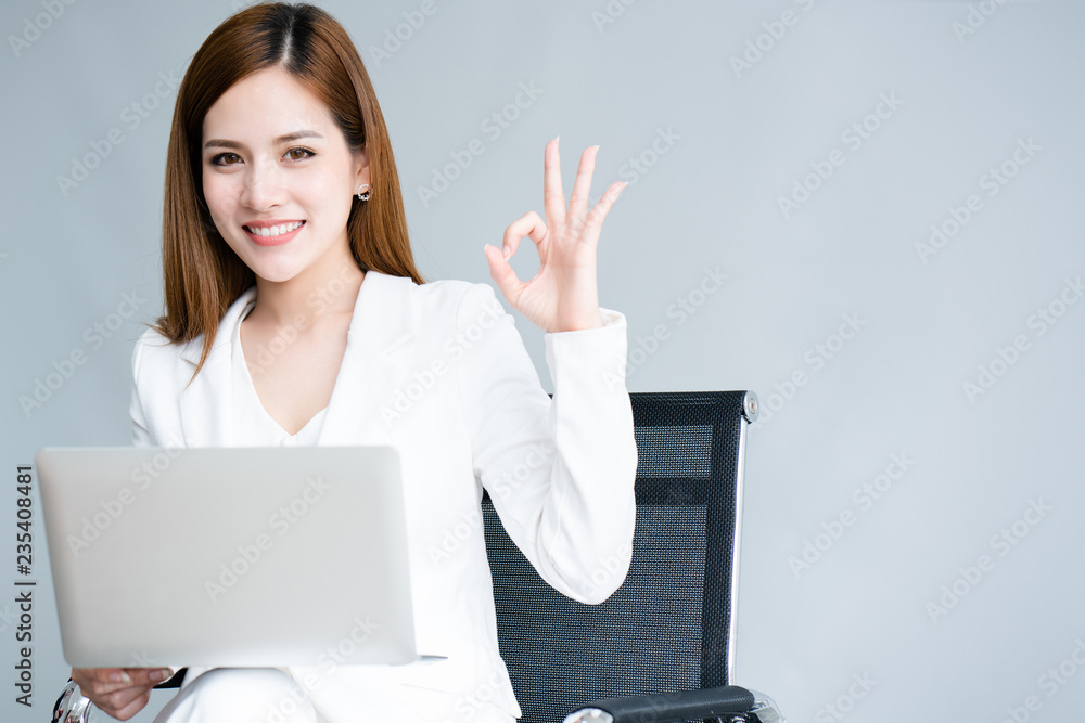 Portrait of a young Asian businesswoman wearing a white dress Opening a working laptop And the job offer information to customers is ok. Good work must be prepared. Because world is changing all time. Portrait of a young Asian businesswoman wearing a white dress Opening a working laptop And the job offer information to customers is ok. Good work must be prepared. Because world is changing all time.
