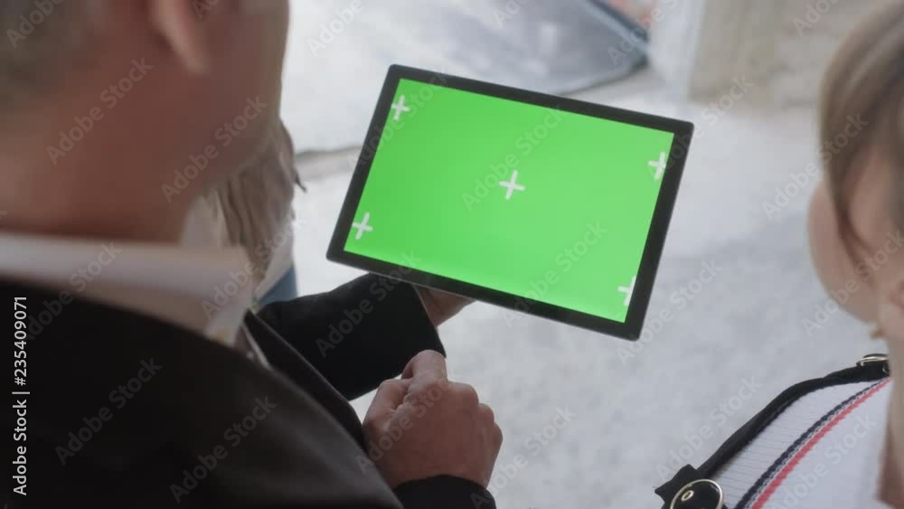 Sales agent holding ipad in new building. Man working as realtor in construction site with digital tablet monitor. Real estate broker showing green screen for internet website