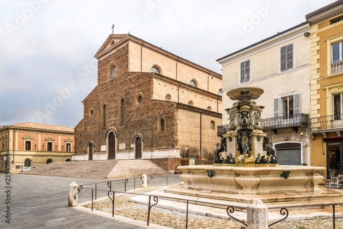 View at the Cathedral of Saint Peter the Apostle and fountain at the Liberty place in Faenza - Italy
