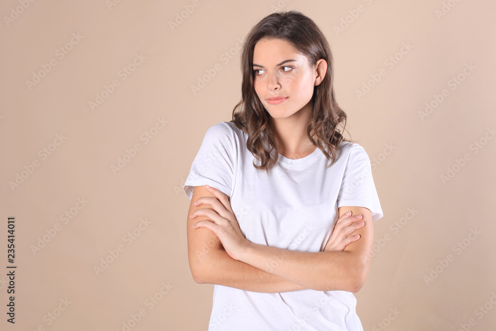 Young woman in casual clothing wondering and screaming isolated over beige background. Young woman in casual clothing wondering and screaming isolated over beige background.
