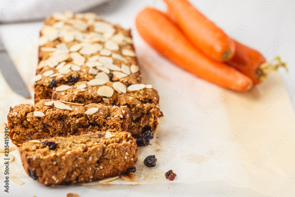 Vegan carrot bread with almonds on a white background. Vegan carrot bread with almonds on a white background.