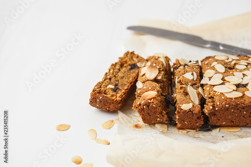 Bild auf Leinwand Vegan carrot bread with almonds on a white background, copy space