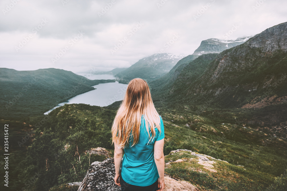 Woman traveling alone in moody mountains active lifestyle hiking adventure summer vacations in Norway outdoor solitude and silence