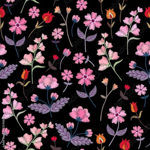 Embroidery seamless pattern with different wild flowers. Vector floral ornament on black background. Satin stitch.