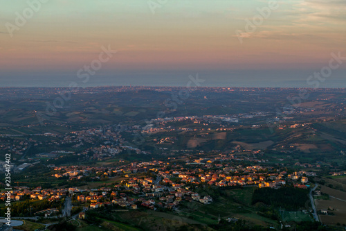 Panorama of Republic of San Marino of Borgo Maggiore on the Sunse on the Sunset. From a bird's eye view . Located on Italian peninsula, on the coast of the Adriatic Sea. Italy. European travel.