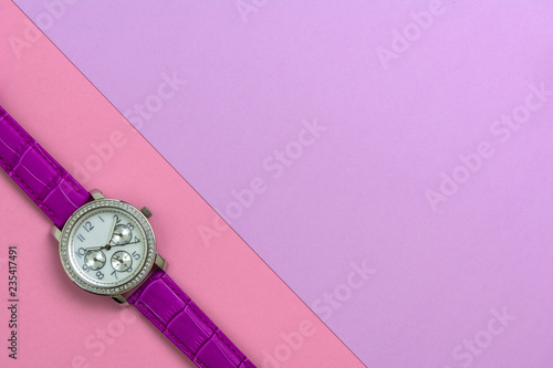 Beautiful women's wrist watch on pink background.